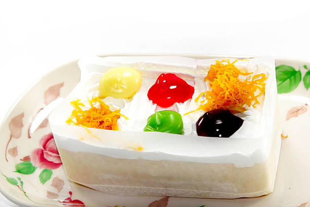 Gourmet dessert closeup with a fresh fruit cake topped with sweet strawberries and raspberries