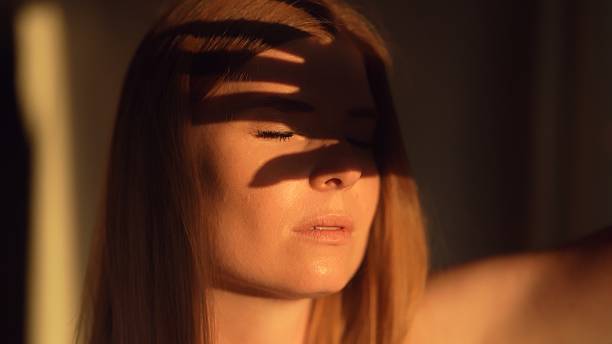 istock A woman covers her face with her hand from the sun. 2230561501