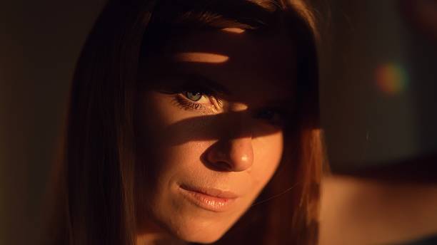 istock A woman covers her face with her hand from the sun. 2230561529