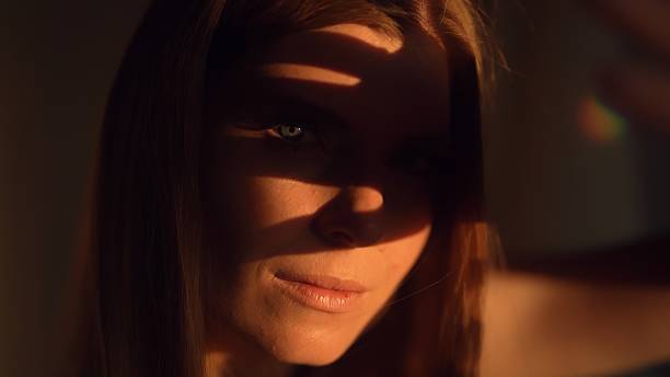 istock A woman covers her face with her hand from the sun. 2230561531