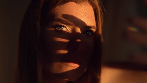 istock A woman covers her face with her hand from the sun. 2230561532