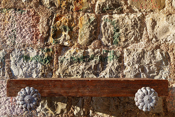 istock empty wooden shelf against old stone wall with contrasting sunlight as background 2230561981
