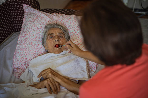 istock Caring for a bedridden elderly woman 2230563235