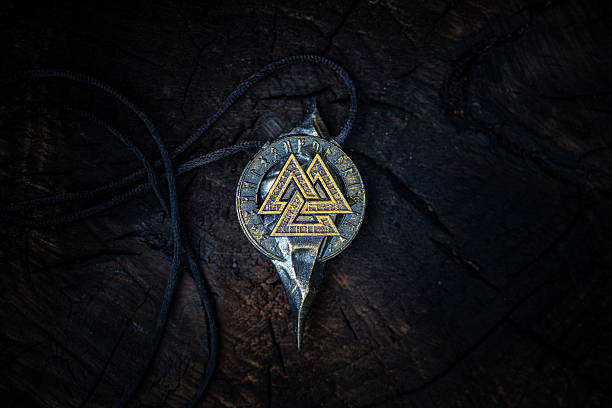 istock Ancient Nordic Symbol - Valknut Rune Design on dark aged background 2230565344