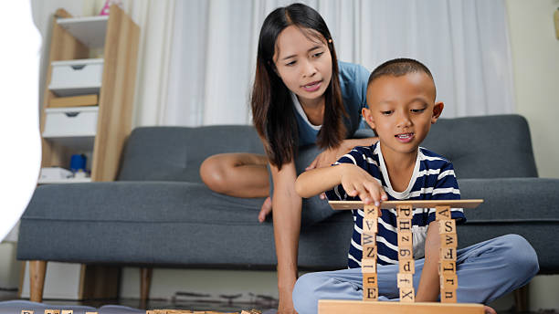 istock Building blocks create fun and educational experience for child and parent. child focuses intently on stacking blocks while parent observes with encouragement 2230565517
