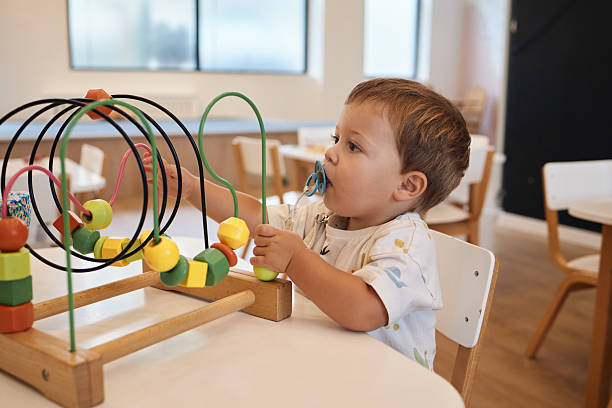 istock Happy baby boy is having fun in the kindergarten 2230569562