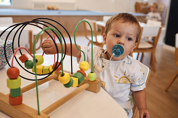 istock Happy baby boy is having fun in the kindergarten 2230569620