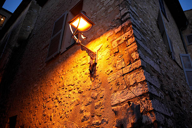 Rustic apartment window reflected in a garden pond as seen long the touristic streets of Saint-Emilion, France