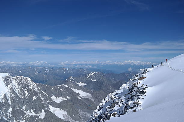 istock Adventurous hiker enjoying the breathtaking view from a snowy mountain peak 2230574171