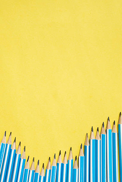 istock Yellow background with vertical space for text and pencils. Back to school flat lay 2230578364