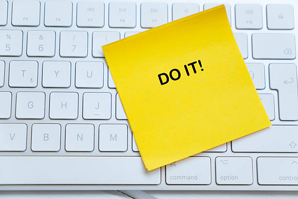 Yellow paper note with Do It on part of keyboard