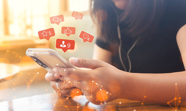 istock Women holding smartphones and using social media network applications or interacting with others or friends by replying to chats or sending emoticons to express their feelings and ideas inside a coffee shop. 2230581214