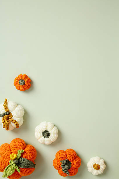 istock Minimalist fall flatlay with handmade crochet pumpkins on soft pastel green background 2230581237