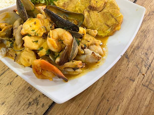 Enjoying a delicious seafood dish with patacones in Puerto Lopez, Machalilla National Park, Manabí, Ecuador