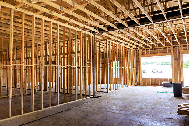 istock Construction progress of building interior shows wooden framing open layout during works day at construction site 2230589858