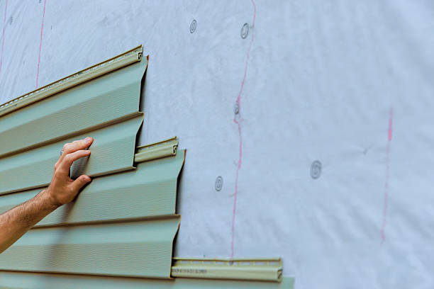 istock Work progresses on modern building exterior with green vinyl paneling installation 2230589902