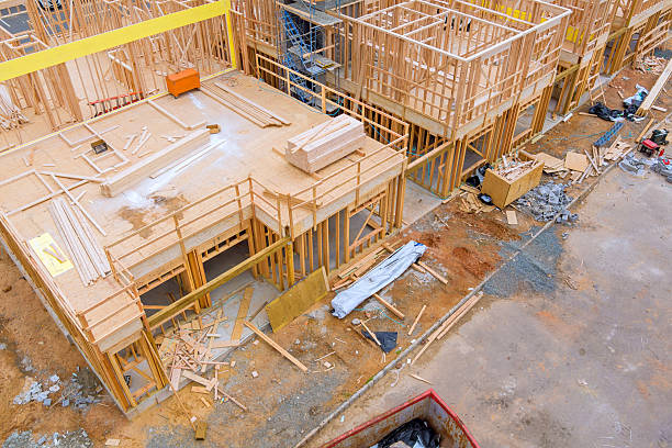 istock Wooden framework under construction at busy building site during works day 2230589919