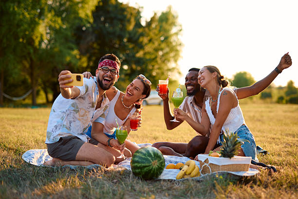 istock Cheerful friends taking a selfie while enjoying a picnic in a park 2230591393