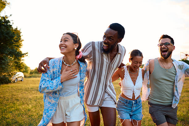 istock Young people walking together in a park and laughing 2230591528