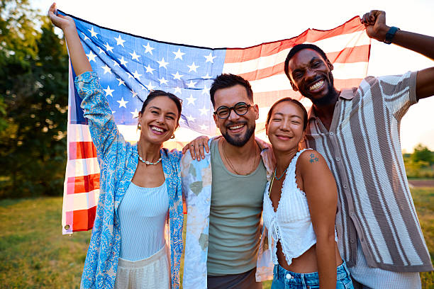 istock Young people holding american flag celebrating independence day 2230591616