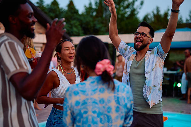 istock Friends dancing and enjoying a pool party at dusk 2230591804
