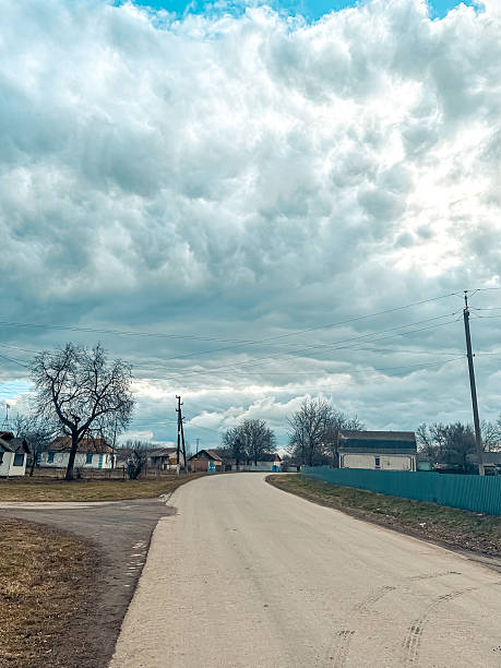 istock Scenic rural road winding through countryside with dramatic cloud formations overhead, showcasing the beauty of nature and tranquility in rural life 2230591818