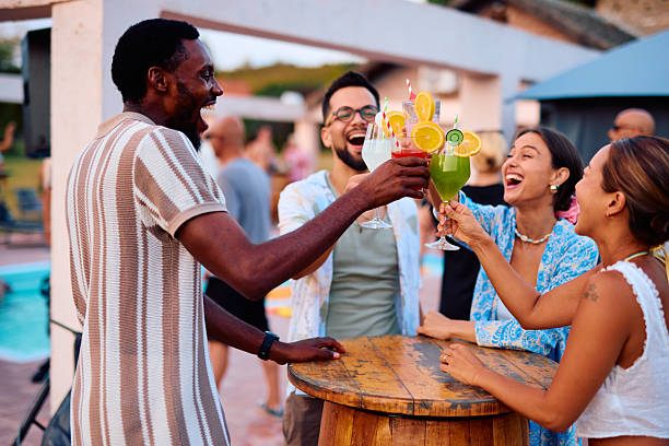 istock Friends toasting cocktails at a pool party 2230592966