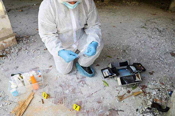 istock Middle-Aged Forensic Investigator With Blue Gloves At Work 2230594014