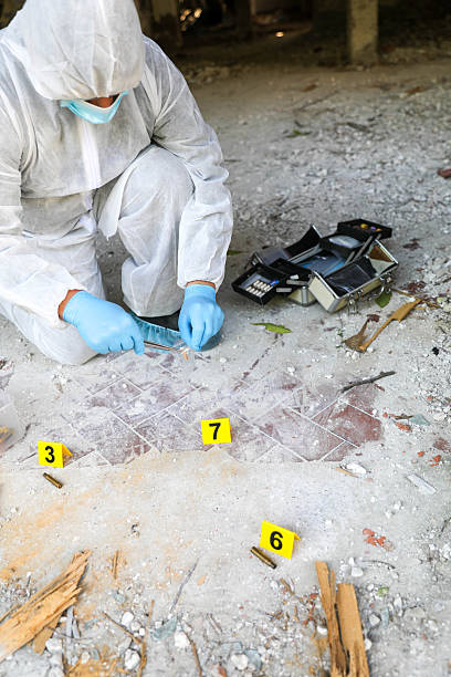Senior forensic scientist doing photographs at crime scene