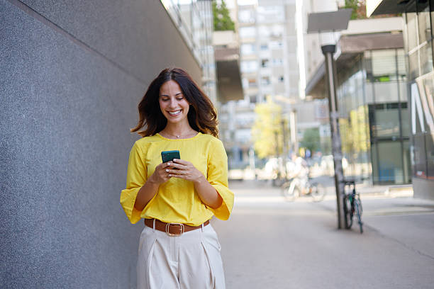 istock Professional female entrepreneur navigating urban landscape, checking smartphone with confident stride during bright daylight hours 2230596069