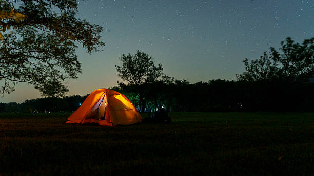 istock Camping at night on a moonlit grassland 2230596969