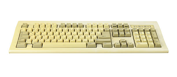 istock Vintage computer keyboard from the 1990s isolated on white background. 2230598815