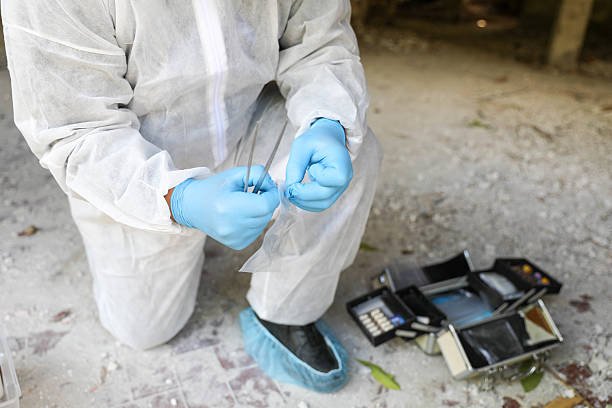 istock Middle-Aged Man In White Suit Conducting Crime Scene Analysis 2230600774