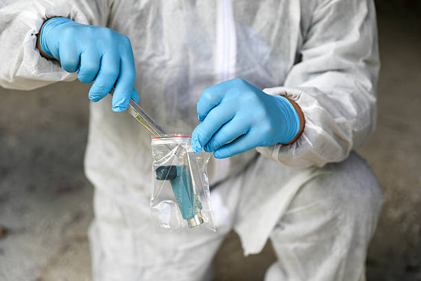 istock Forensic Scientist Wearing Mask, Glasses, And Gloves At Work 2230601568