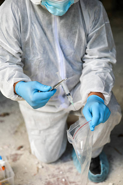istock Forensic Scientist Wearing Mask, Glasses, And Gloves At Work 2230601631