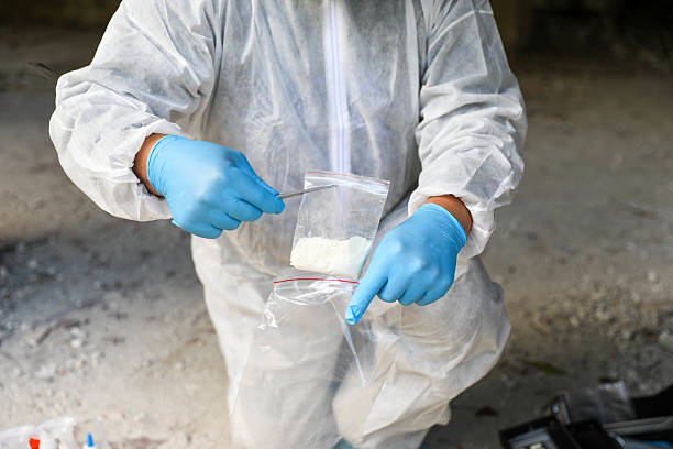 istock Middle-Aged Crime Scene Expert In White Protective Clothing 2230601686