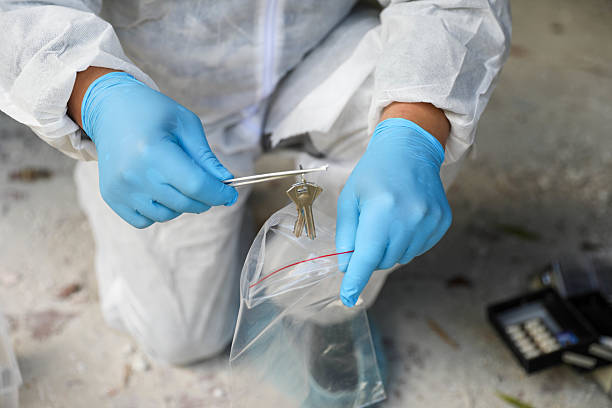 istock Middle-Aged Male Forensic Expert Wearing Mask And Gloves 2230601738