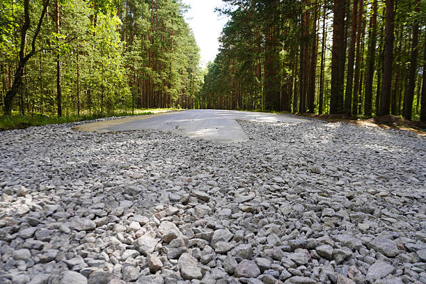 istock Road construction making new asphalt road in forest landscape 2230604202