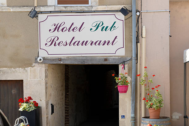 Hotel pub restaurant sign indicating services offered welcoming customers with flower pots