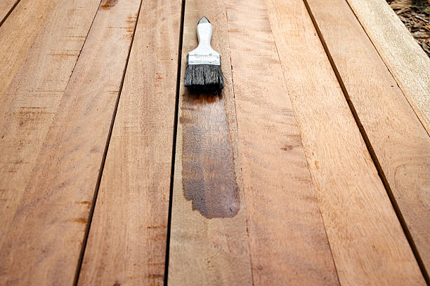 istock Paint brush and wood material in construction work. 2230609102