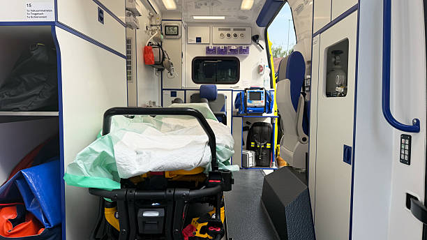 istock Ambulance emergency vehicle on white background with open rear doors, fully equipped interior showing stretcher, patient bed and medical equipment, modern paramedic transport and healthcare service concept 2230611761