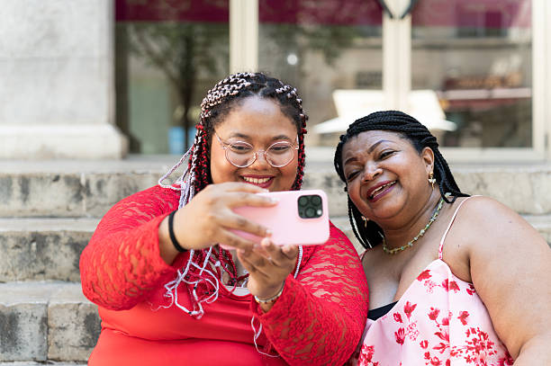 istock Mother and daughter taking a selfie on city steps 2230617371
