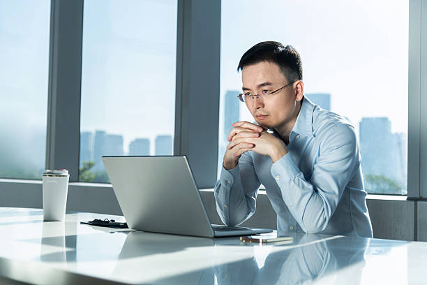 istock Businessman using laptop by the window 2230626086