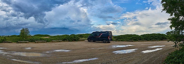 Tallinn, Estonia - 07 04 2023: Camper Van parked along the shores of the coastline of the gulf of bothnia in Estonia on an overcast day.
