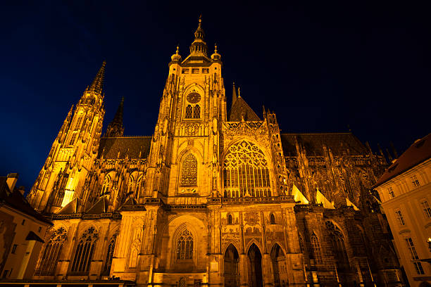 St. Vitus Cathedral glowing gold at night in Prague Castle, Czech Republic