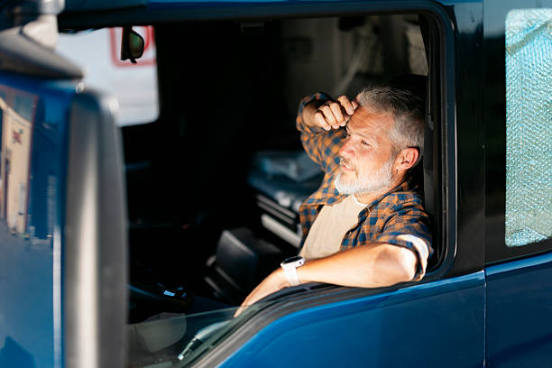 istock Tired truck driver relaxing in cabin during break 2230629787