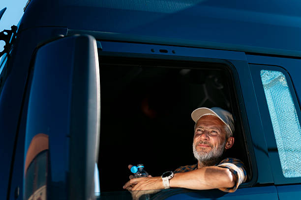 istock Truck driver resting and enjoying the view from his cabin 2230629799
