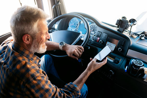 istock Truck driver using smartphone inside modern truck cabin 2230629814