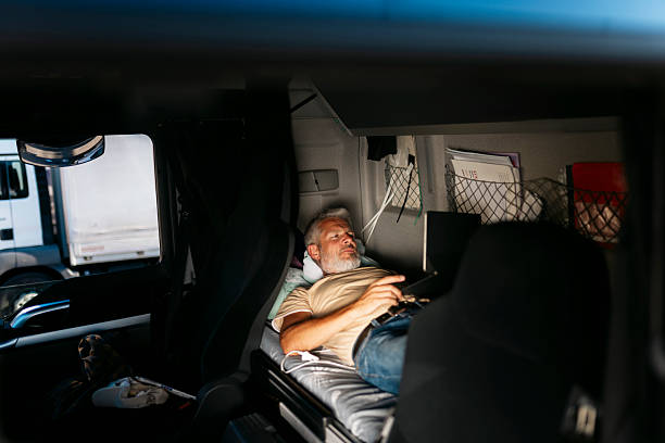 istock Truck driver relaxing on bunk bed with laptop 2230629822