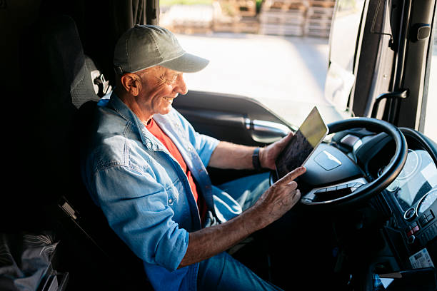 istock Senior truck driver using digital tablet in his truck 2230629858